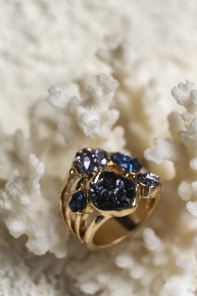 expensive golden ring displayed white coral background